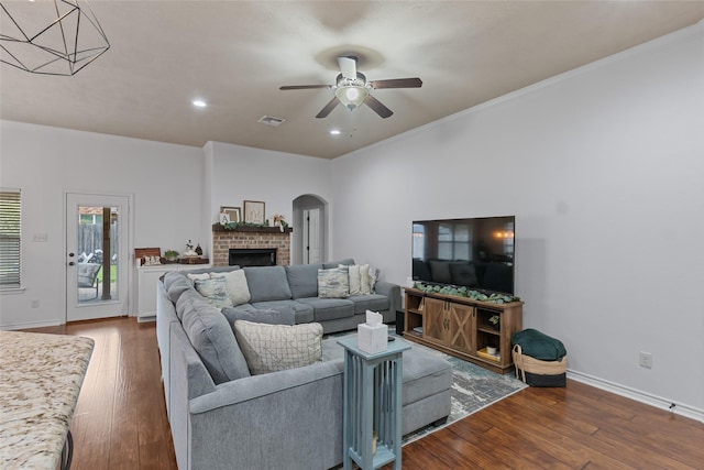 4202 Carnes Ct S, College Station, TX 77845 - living room with arched walkways, wood finished floors, ceiling fan, a brick fireplace, and recessed lighting