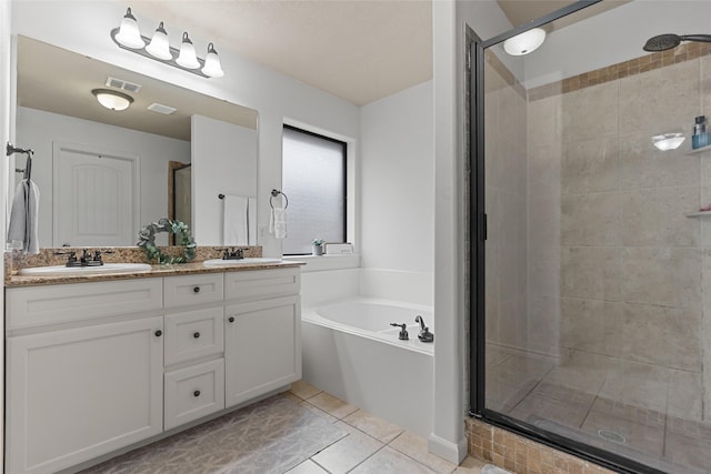4202 Carnes Ct S, College Station, TX 77845 - bathroom with a stall shower, double vanity, a bath, and tile patterned floors