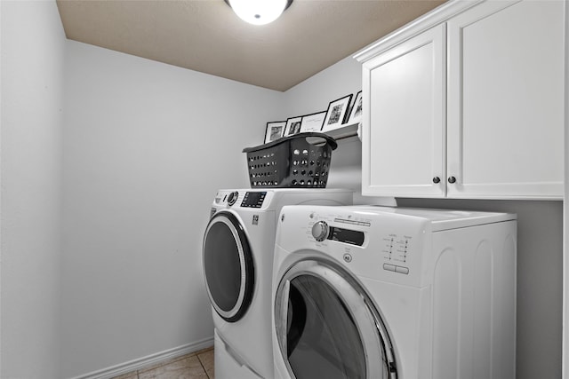 4202 Carnes Ct S, College Station, TX 77845 - laundry room featuring washer and clothes dryer, cabinet space, and light tile patterned floors