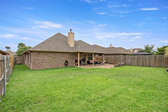 4202 Carnes Ct S, College Station, TX 77845 - rear view of property featuring a fenced backyard, brick siding, a patio, a shingled roof, and a chimney