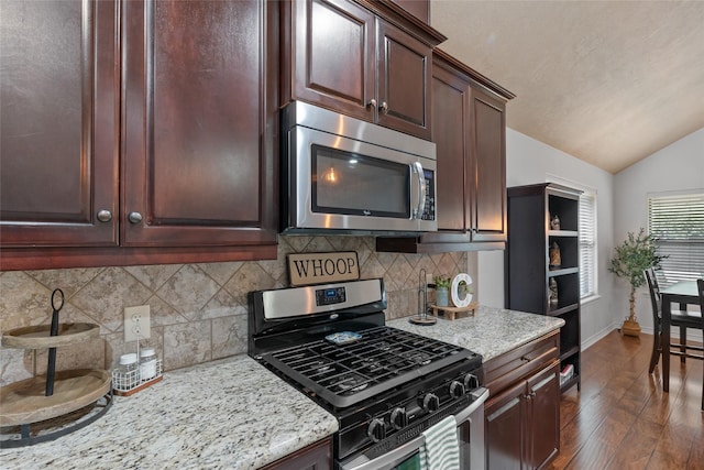 4202 Carnes Ct S, College Station, TX 77845 - kitchen with stainless steel appliances, lofted ceiling, dark wood-type flooring, decorative backsplash, and dark brown cabinets