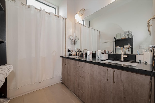 2401 Crawford St Unit C2A, Houston, TX 77004 - full bathroom with double vanity, tile patterned floors, and shower / tub combo