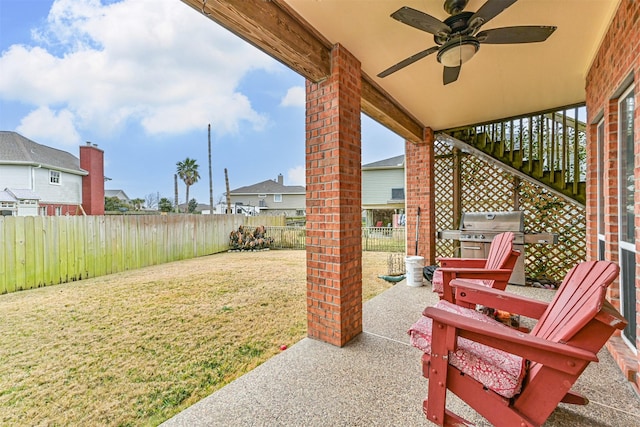 12811 E Conquistador, Galveston, TX 77554 - fenced backyard with area for grilling, a ceiling fan, a patio, and stairway