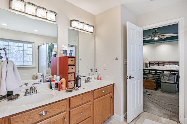 12811 E Conquistador, Galveston, TX 77554 - full bath with double vanity, connected bathroom, tile patterned flooring, a ceiling fan, and a shower