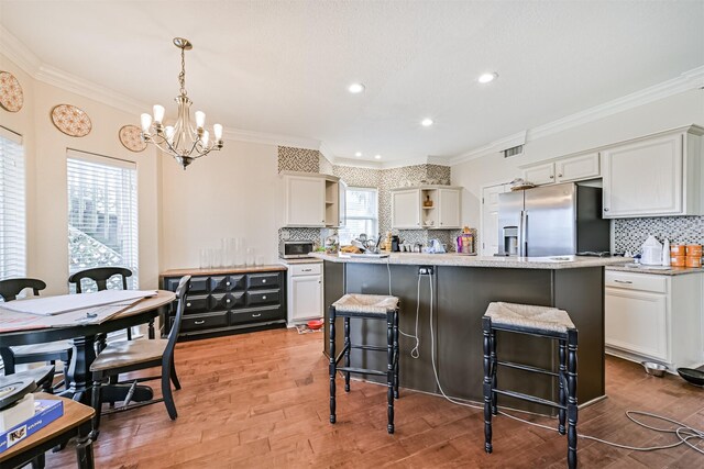 12811 E Conquistador, Galveston, TX 77554 - kitchen featuring stainless steel appliances, open shelves, ornamental molding, a chandelier, and tasteful backsplash