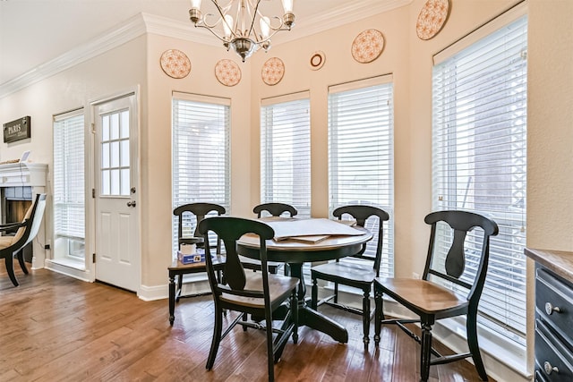 12811 E Conquistador, Galveston, TX 77554 - dining area featuring wood finished floors, healthy amount of natural light, crown molding, and a chandelier