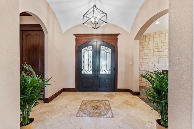 2830 Airport Rd, Brenham, TX 77833 - entrance foyer featuring arched walkways, a chandelier, french doors, and vaulted ceiling