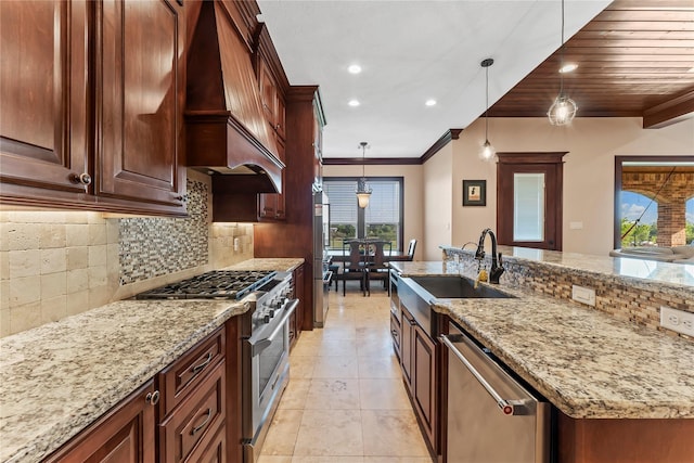 2830 Airport Rd, Brenham, TX 77833 - kitchen featuring appliances with stainless steel finishes, wall chimney exhaust hood, ornamental molding, decorative backsplash, and decorative light fixtures