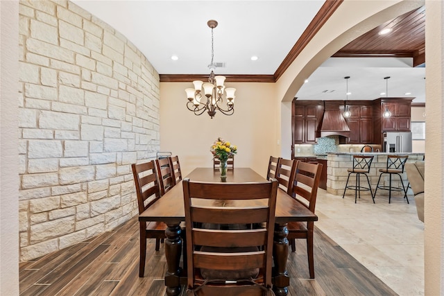 2830 Airport Rd, Brenham, TX 77833 - dining area featuring ornamental molding, arched walkways, a chandelier, recessed lighting, and dark wood-style flooring