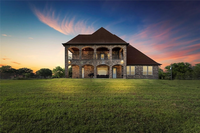 2830 Airport Rd, Brenham, TX 77833 - french country home featuring a balcony, a front lawn, and stone siding