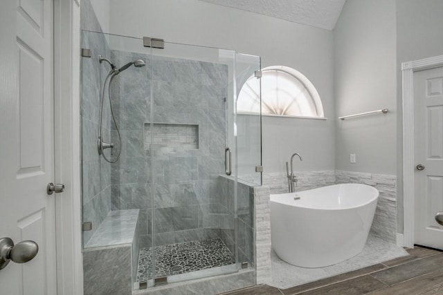 6302 Laver Love Dr, Spring, TX 77379 - bathroom with a freestanding tub, tile walls, a shower stall, wood finished floors, and a wainscoted wall