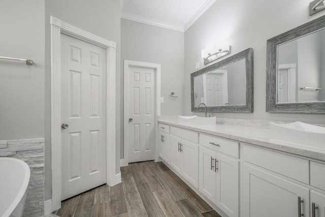 6302 Laver Love Dr, Spring, TX 77379 - full bath with double vanity, a freestanding bath, crown molding, and wood finished floors