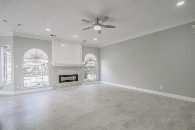 6302 Laver Love Dr, Spring, TX 77379 - unfurnished living room featuring a glass covered fireplace, a ceiling fan, ornamental molding, a textured ceiling, and recessed lighting