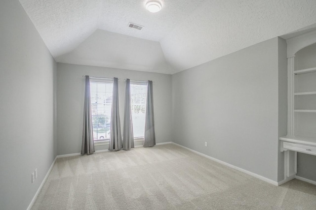 6302 Laver Love Dr, Spring, TX 77379 - spare room with light colored carpet, a textured ceiling, and lofted ceiling
