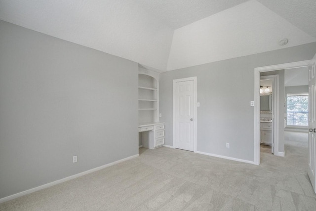 6302 Laver Love Dr, Spring, TX 77379 - unfurnished bedroom with light carpet, high vaulted ceiling, and an office area