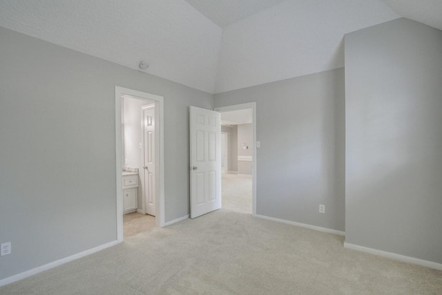 6302 Laver Love Dr, Spring, TX 77379 - unfurnished bedroom with vaulted ceiling, light colored carpet, and ensuite bathroom