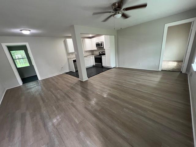 2227 Westway St, Orange, TX 77630 - unfurnished living room featuring ceiling fan and dark wood-style flooring