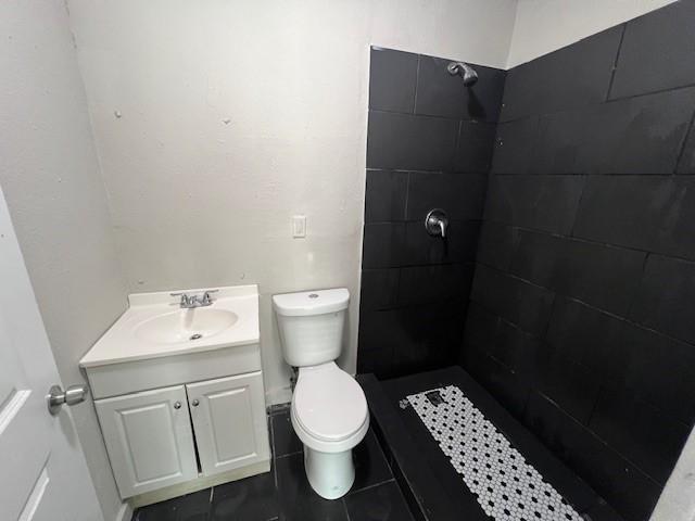 2227 Westway St, Orange, TX 77630 - full bathroom featuring vanity and tiled shower