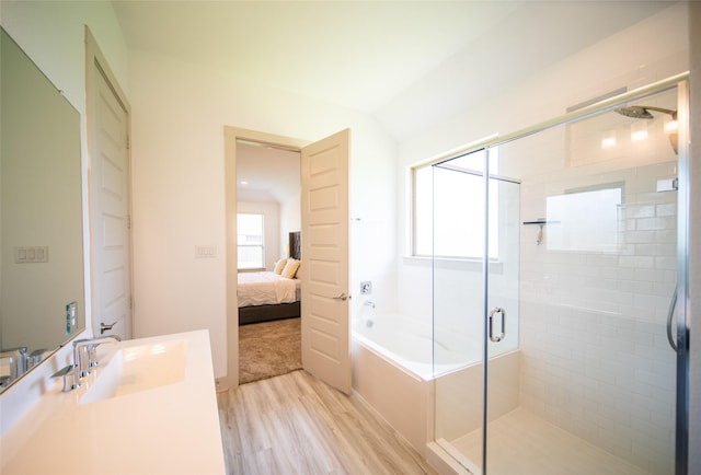 127 Dorado Dr, Friendswood, TX 77546 - ensuite bathroom featuring wood finished floors, a shower stall, vanity, a bath, and lofted ceiling