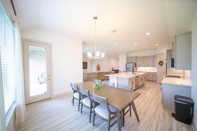 127 Dorado Dr, Friendswood, TX 77546 - dining space featuring light wood finished floors, healthy amount of natural light, a chandelier, recessed lighting, and vaulted ceiling