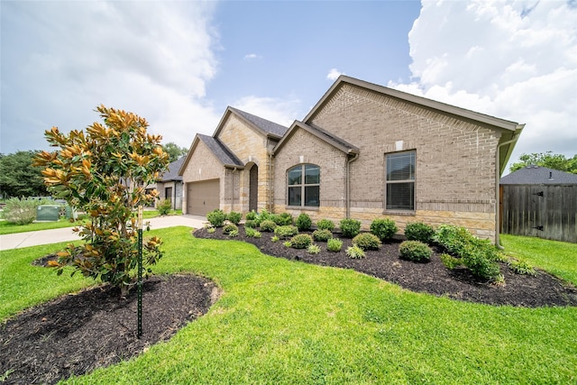 127 Dorado Dr, Friendswood, TX 77546 - french country style house with brick siding, concrete driveway, and an attached garage