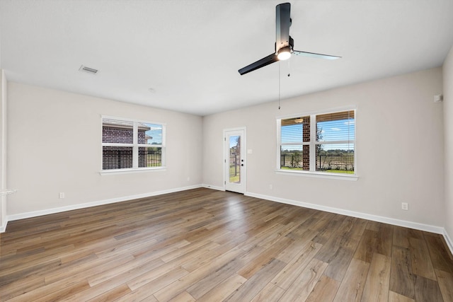 3004 Myrtle Sunset Dr, Katy, TX 77493 - spare room featuring ceiling fan, healthy amount of natural light, and wood finished floors