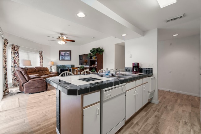 12800 Melville Dr Unit B207, Montgomery, TX 77356 - kitchen with tile counters, dishwasher, light wood finished floors, a peninsula, and recessed lighting
