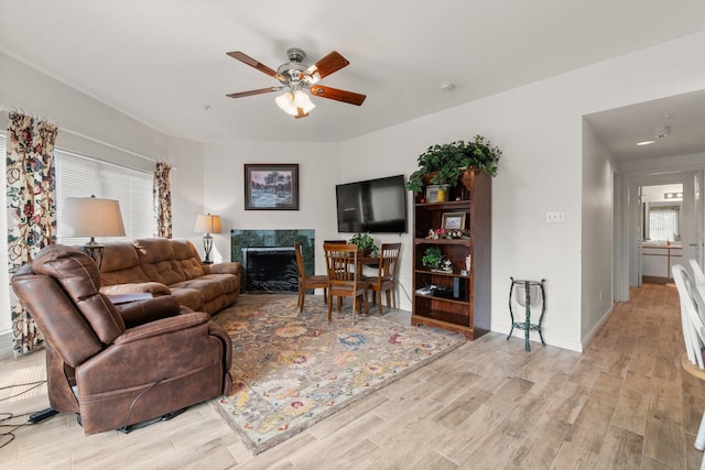 12800 Melville Dr Unit B207, Montgomery, TX 77356 - living room featuring ceiling fan, wood finished floors, and a high end fireplace