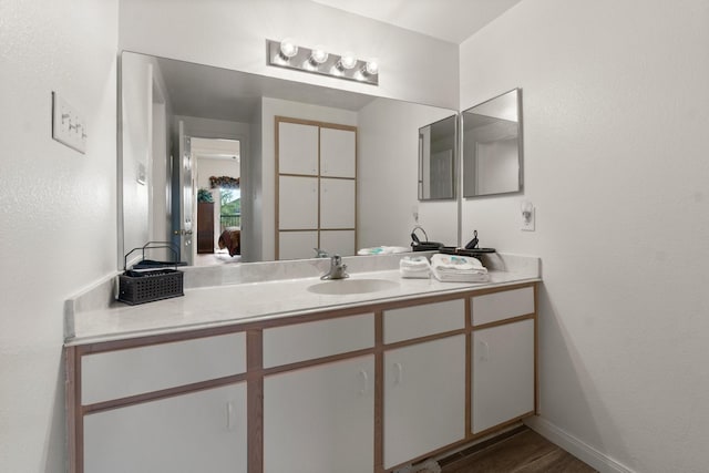 12800 Melville Dr Unit B207, Montgomery, TX 77356 - bathroom featuring vanity and wood finished floors