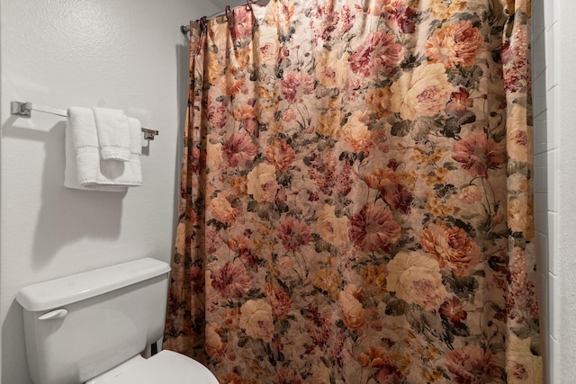 12800 Melville Dr Unit B207, Montgomery, TX 77356 - bathroom featuring toilet and curtained shower