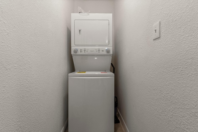 12800 Melville Dr Unit B207, Montgomery, TX 77356 - laundry area with stacked washing machine and dryer and a textured wall