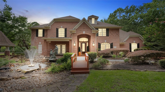 37703 Edgewater Dr, Pinehurst, TX 77362 - colonial home with french doors, brick siding, and a lawn