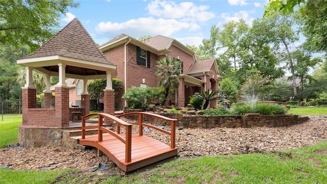 37703 Edgewater Dr, Pinehurst, TX 77362 - back of property featuring a gazebo, brick siding, and a shingled roof