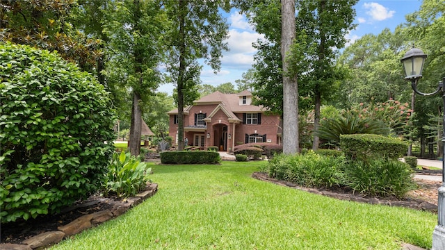 37703 Edgewater Dr, Pinehurst, TX 77362 - view of front of property featuring a front lawn and brick siding