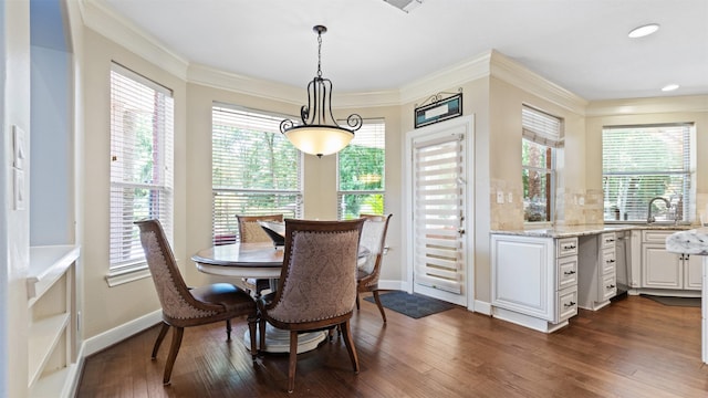 37703 Edgewater Dr, Pinehurst, TX 77362 - dining area with healthy amount of natural light, dark wood finished floors, and crown molding