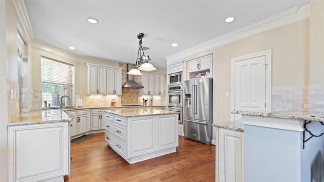 37703 Edgewater Dr, Pinehurst, TX 77362 - kitchen with stainless steel appliances, wall chimney range hood, ornamental molding, backsplash, and a center island
