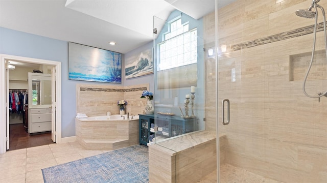 37703 Edgewater Dr, Pinehurst, TX 77362 - full bathroom featuring a stall shower, a bath, tile patterned floors, and a spacious closet