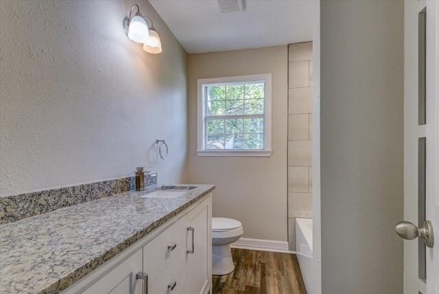 3802 Ranch St, Houston, TX 77026 - bathroom with wood finished floors, vanity, and bathtub / shower combination