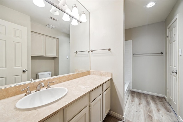3200 Bellefontaine St Unit 72, Houston, TX 77025 - bathroom with wood finished floors, vanity, and tub / shower combination