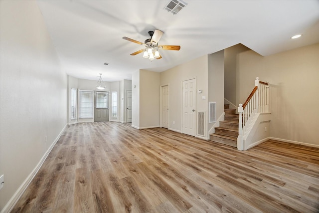 3200 Bellefontaine St Unit 72, Houston, TX 77025 - unfurnished living room featuring light wood-style floors, stairway, and a ceiling fan