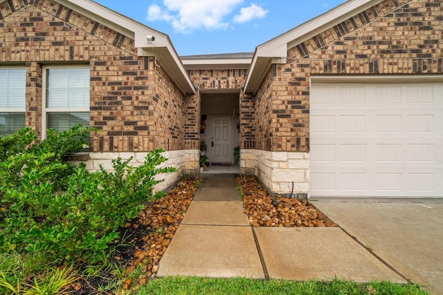 5315 Shady Olive St, Katy, TX 77449 - entrance to property featuring an attached garage, brick siding, driveway, and stone siding