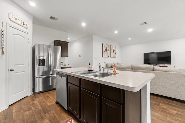 5315 Shady Olive St, Katy, TX 77449 - kitchen with stainless steel appliances, dark wood finished floors, light countertops, a kitchen island with sink, and dark brown cabinetry
