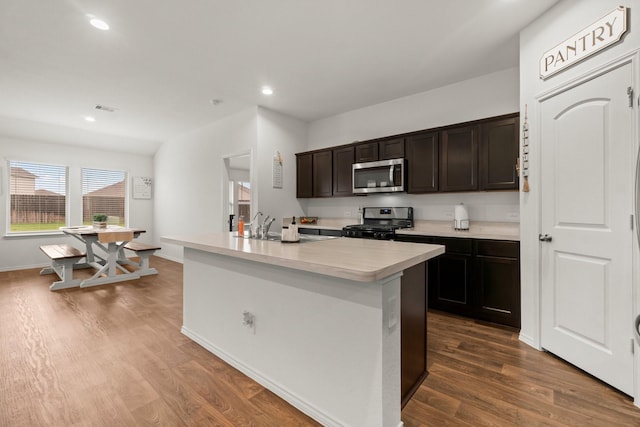 5315 Shady Olive St, Katy, TX 77449 - kitchen featuring gas stove, plenty of natural light, dark wood-style floors, stainless steel microwave, and recessed lighting