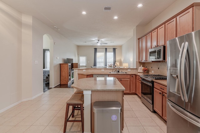 2954 Smokey Forest Ln, Spring, TX 77386 - kitchen featuring appliances with stainless steel finishes, recessed lighting, backsplash, a peninsula, and light countertops