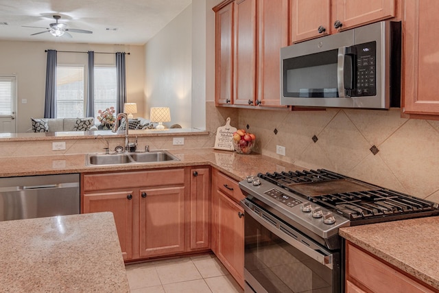 2954 Smokey Forest Ln, Spring, TX 77386 - kitchen featuring appliances with stainless steel finishes, healthy amount of natural light, tasteful backsplash, and ceiling fan