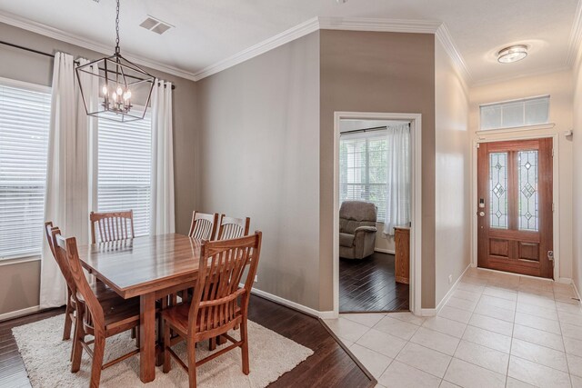 2954 Smokey Forest Ln, Spring, TX 77386 - dining room featuring a chandelier, ornamental molding, and light wood-type flooring
