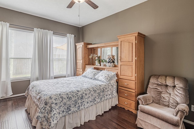 2954 Smokey Forest Ln, Spring, TX 77386 - bedroom featuring dark wood-style flooring, multiple windows, and a ceiling fan