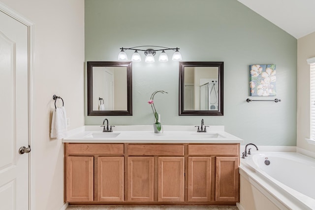 2954 Smokey Forest Ln, Spring, TX 77386 - bathroom featuring double vanity, a garden tub, and lofted ceiling