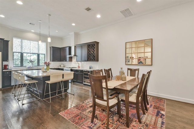 3937 Law St, Houston, TX 77005 - dining space with crown molding, wine cooler, dark wood-style floors, and recessed lighting