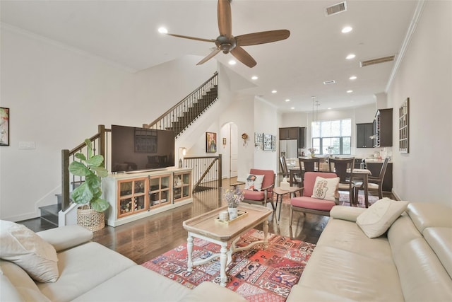 3937 Law St, Houston, TX 77005 - living room featuring stairway, arched walkways, wood finished floors, ceiling fan, and ornamental molding